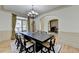 Elegant dining area with hardwood floors, chandelier, and an open layout at 1806 Royal Troon Ct, Duluth, GA 30097