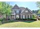 Charming two-story brick home featuring well-maintained landscaping and a welcoming front entrance at 1806 Royal Troon Ct, Duluth, GA 30097