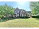 Beautiful two-story brick home with manicured lawn and mature trees in an established neighborhood at 1806 Royal Troon Ct, Duluth, GA 30097