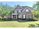 Lovely brick home with a spacious front yard and mature trees offering curb appeal at 1806 Royal Troon Ct, Duluth, GA 30097