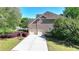 Two-car garage and brick exterior of this home with a long driveway and beautifully landscaped yard at 1806 Royal Troon Ct, Duluth, GA 30097