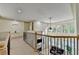 Bright hallway with neutral walls, wood trim, staircase, black wrought iron bannister, and an open view to the living room below at 1806 Royal Troon Ct, Duluth, GA 30097