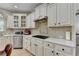 Gourmet kitchen with stainless steel appliances and light stone countertops at 1806 Royal Troon Ct, Duluth, GA 30097