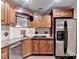 Contemporary kitchen with stainless steel appliances, wooden cabinets, and granite countertops at 1806 Royal Troon Ct, Duluth, GA 30097