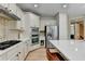 Bright kitchen with island seating, stainless appliances, and tiled backsplash at 1806 Royal Troon Ct, Duluth, GA 30097
