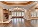 Spacious living room featuring a fireplace, large windows, and tile floors, providing ample natural light and scenic views at 1806 Royal Troon Ct, Duluth, GA 30097