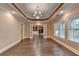 Bright and airy living room featuring hardwood floors and french doors to the back patio at 1806 Royal Troon Ct, Duluth, GA 30097
