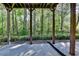 A ground-level patio surrounded by trees at 1806 Royal Troon Ct, Duluth, GA 30097
