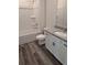 Clean bathroom features shower and tub combo, granite countertops, white cabinets, and modern fixtures at 586 Rodeo Dr, Auburn, GA 30102