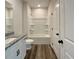 Clean bathroom features shower and tub combo, granite countertops, white cabinets, and modern fixtures at 586 Rodeo Dr, Auburn, GA 30102