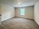 Spacious bedroom featuring plush carpeting and a bright window at 586 Rodeo Dr, Auburn, GA 30102