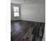 This bedroom features stylish wood-look flooring and a window allowing for plenty of natural light at 586 Rodeo Dr, Auburn, GA 30102