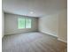 Large carpeted bedroom filled with natural light and neutral paint at 586 Rodeo Dr, Auburn, GA 30102