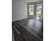 Bedroom features dark hardwood flooring, multiple windows, and views to the surrounding community at 586 Rodeo Dr, Auburn, GA 30102