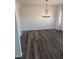 A dining room with dark hardwood flooring, a modern chandelier, and decorative wainscoting at 586 Rodeo Dr, Auburn, GA 30102