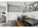 Dining room with a dark wood table, bench seating, decorative lighting, and modern decor at 586 Rodeo Dr, Auburn, GA 30102