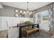 Bright dining room features stylish chandelier, rustic table, and decor with a neutral color palette at 586 Rodeo Dr, Auburn, GA 30102