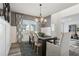 Dining room features a modern table with seating, stylish lighting, and large window at 586 Rodeo Dr, Auburn, GA 30102
