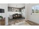 Dining room with a dark wood table, bench seating, decorative lighting, front door and modern decor at 586 Rodeo Dr, Auburn, GA 30102