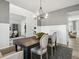 Dining room features a modern table with seating, stylish lighting, and an office in the background at 586 Rodeo Dr, Auburn, GA 30102