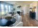 A bright living room features a fireplace, multiple windows, and a view into the dining area at 586 Rodeo Dr, Auburn, GA 30102