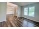 Living room featuring wood flooring and a large window for plenty of natural light at 586 Rodeo Dr, Auburn, GA 30102