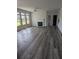 Open living room with fireplace, ceiling fan, and large windows for abundant natural light at 586 Rodeo Dr, Auburn, GA 30102
