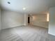 Upstairs loft area with neutral-colored walls and plush carpeting at 586 Rodeo Dr, Auburn, GA 30102