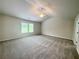 Large main bedroom featuring plush carpet, ceiling fan, and windows at 586 Rodeo Dr, Auburn, GA 30102
