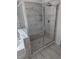 This shower features glass doors, a shower head, and a built-in bench at 586 Rodeo Dr, Auburn, GA 30102