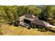 A private backyard oasis with pool and patio furniture surrounded by mature trees at 1762 Patrick Rd, Dacula, GA 30019