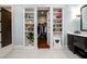 Bathroom with hidden closet, dual vanities and open shelving at 1762 Patrick Rd, Dacula, GA 30019