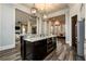Kitchen island with granite counters, stainless steel appliances, and modern pendant lighting at 1762 Patrick Rd, Dacula, GA 30019