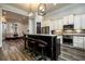 A kitchen with an island, stainless steel appliances, and light colored cabinets at 1762 Patrick Rd, Dacula, GA 30019