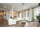 Open concept living room with hardwood floors, modern decor, and abundant natural light at 1762 Patrick Rd, Dacula, GA 30019