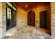 Brick patio with large wood doors and decorative stone flooring at 1762 Patrick Rd, Dacula, GA 30019