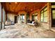 Covered porch with wood ceiling, swing, and beautiful stone flooring at 1762 Patrick Rd, Dacula, GA 30019