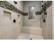 Custom shower with built in seat, decorative tile accent, and dual shower heads at 1762 Patrick Rd, Dacula, GA 30019