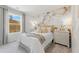 Cozy bedroom featuring soft lighting, floral wallpaper, and a comfortable bed at 8511 Polston Place- Lot 138, Douglasville, GA 30134