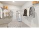 Walk-in closet with ample shelving and storage space, plus a tufted ottoman at 8511 Polston Place- Lot 138, Douglasville, GA 30134
