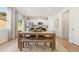 Charming dining area with a rustic wood table, modern decor, and a view into the stylish kitchen at 8511 Polston Place- Lot 138, Douglasville, GA 30134
