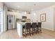 Bright kitchen features white cabinets, stainless steel appliances, and a central island with seating at 8511 Polston Place- Lot 138, Douglasville, GA 30134