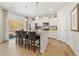 Modern kitchen island with bar seating, pendant lighting, and sleek white cabinets at 8511 Polston Place- Lot 138, Douglasville, GA 30134