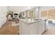 Open-concept kitchen with island, granite countertops, and views of living and dining areas at 8511 Polston Place- Lot 138, Douglasville, GA 30134