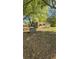 Spacious backyard with trees showing the back of the house with added concrete structure at 1099 Warren Dr, Riverdale, GA 30296