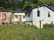 A side view of the house showcasing its exterior, with a section needing work and surrounded by greenery at 1099 Warren Dr, Riverdale, GA 30296