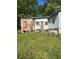 A side view of the house with unkempt yard showcasing its exterior, with a section needing work at 1099 Warren Dr, Riverdale, GA 30296