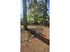 Exterior view of the home from a distance, surrounded by trees in a greenery filled lot at 1099 Warren Dr, Riverdale, GA 30296