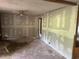 Unfinished living room showing plaster and exposed beams and ceiling fan installation at 1099 Warren Dr, Riverdale, GA 30296