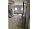 Living room shows water heater and mosaic flooring, evidence of weathering and renovation needs at 1099 Warren Dr, Riverdale, GA 30296